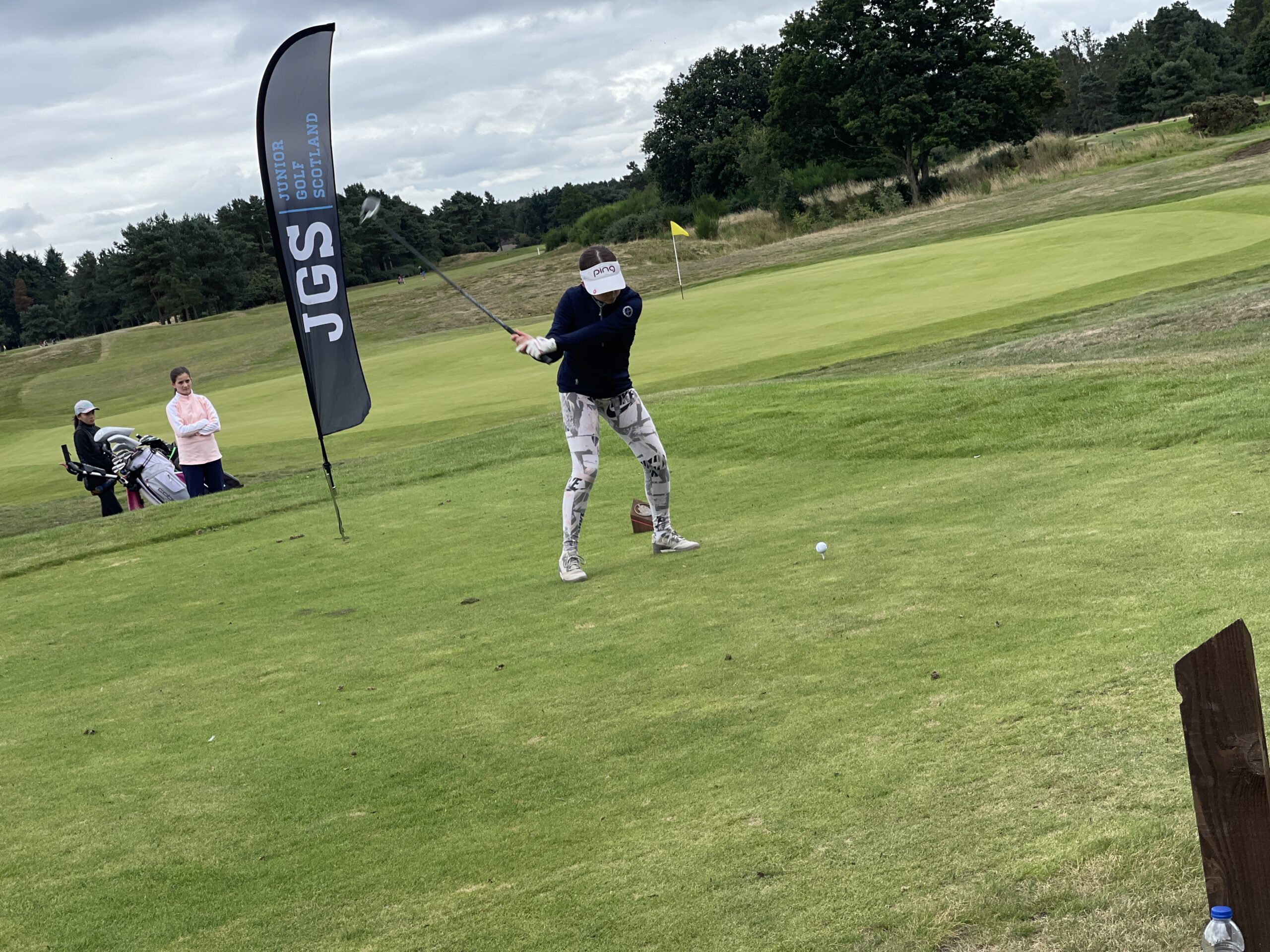 Coach fist-bumping junior golfer at camp